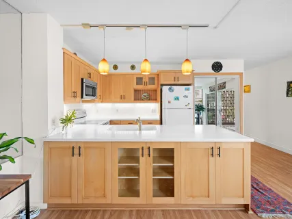 a picture of a kitchen with cabinets and window