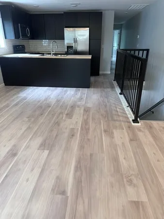 a living room with a couch and a wooden floor