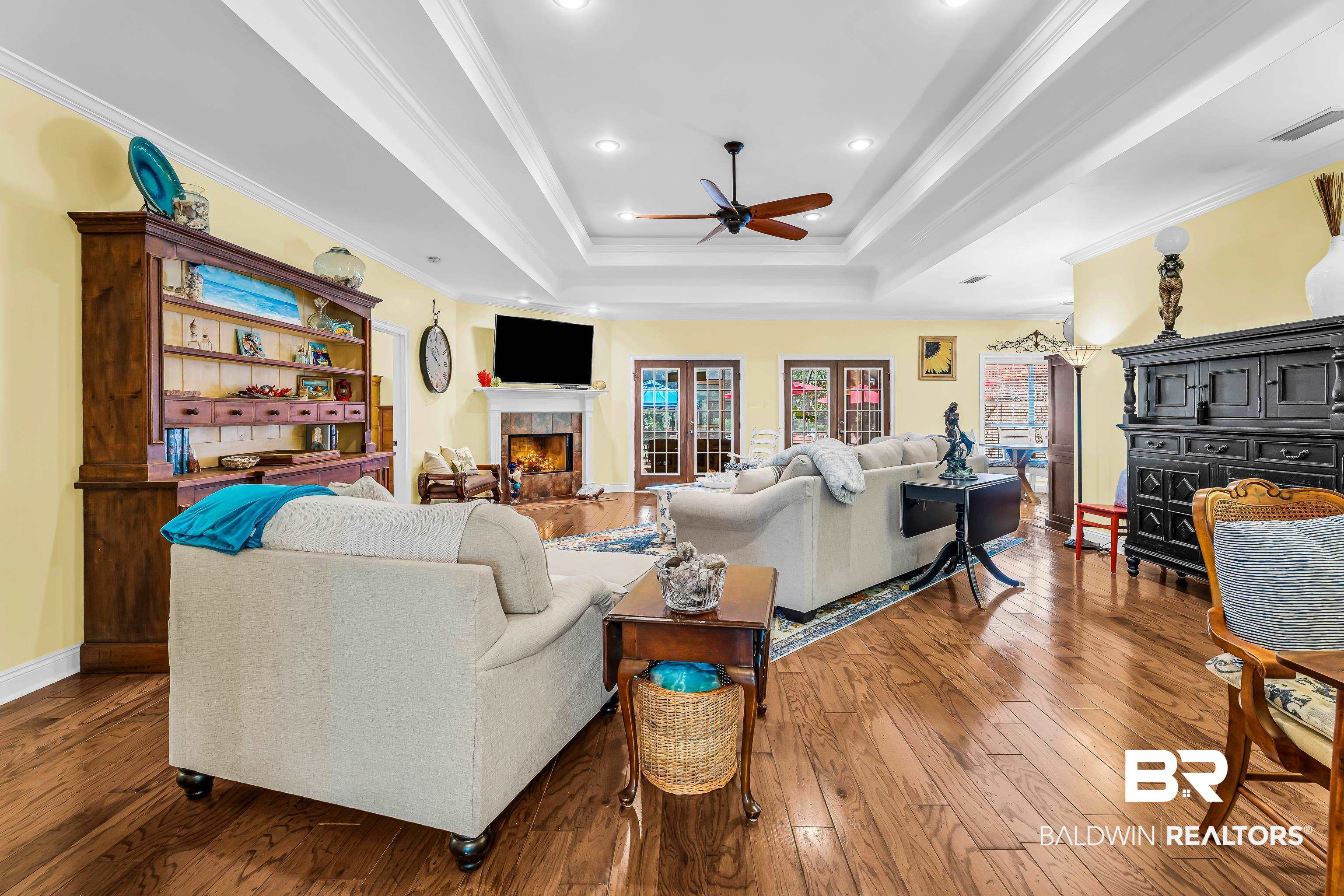 7014 Blakeley Road Daphne, AL 36527 - Photo 23 of 45 Spacious living area featuring wood-finish flooring, a coffered ceiling with recessed lighting, and a ceiling fan