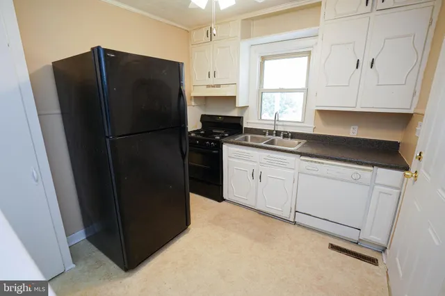 a kitchen with a refrigerator and a stove