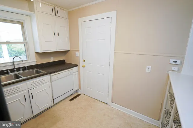 a kitchen with a sink and cabinets