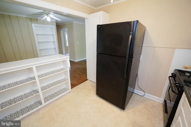 a view of kitchen with refrigerator and wooden floor