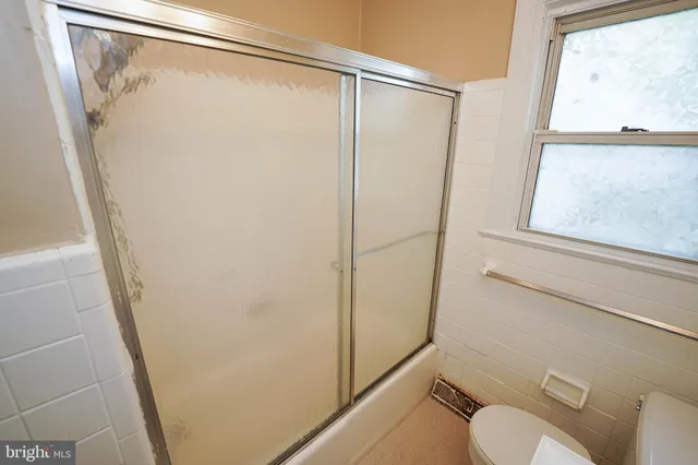 a bathroom with a shower and a toilet
