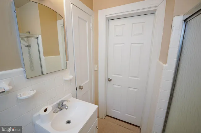 a bathroom with a sink and mirror with toilet