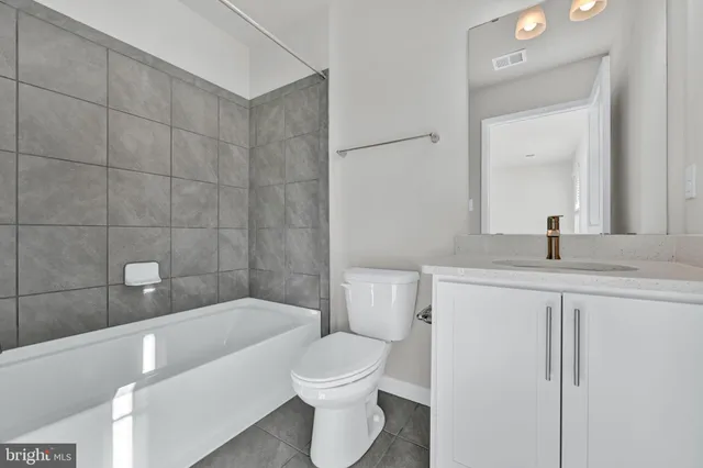 a bathroom with a bathtub a sink a toilet and a mirror