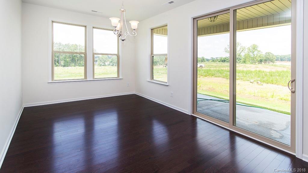 5549 Braddock Ml Way, Unit 264 Lancaster, SC 29720 - Photo 16 of 23 a view of an empty room with wooden floor and windows