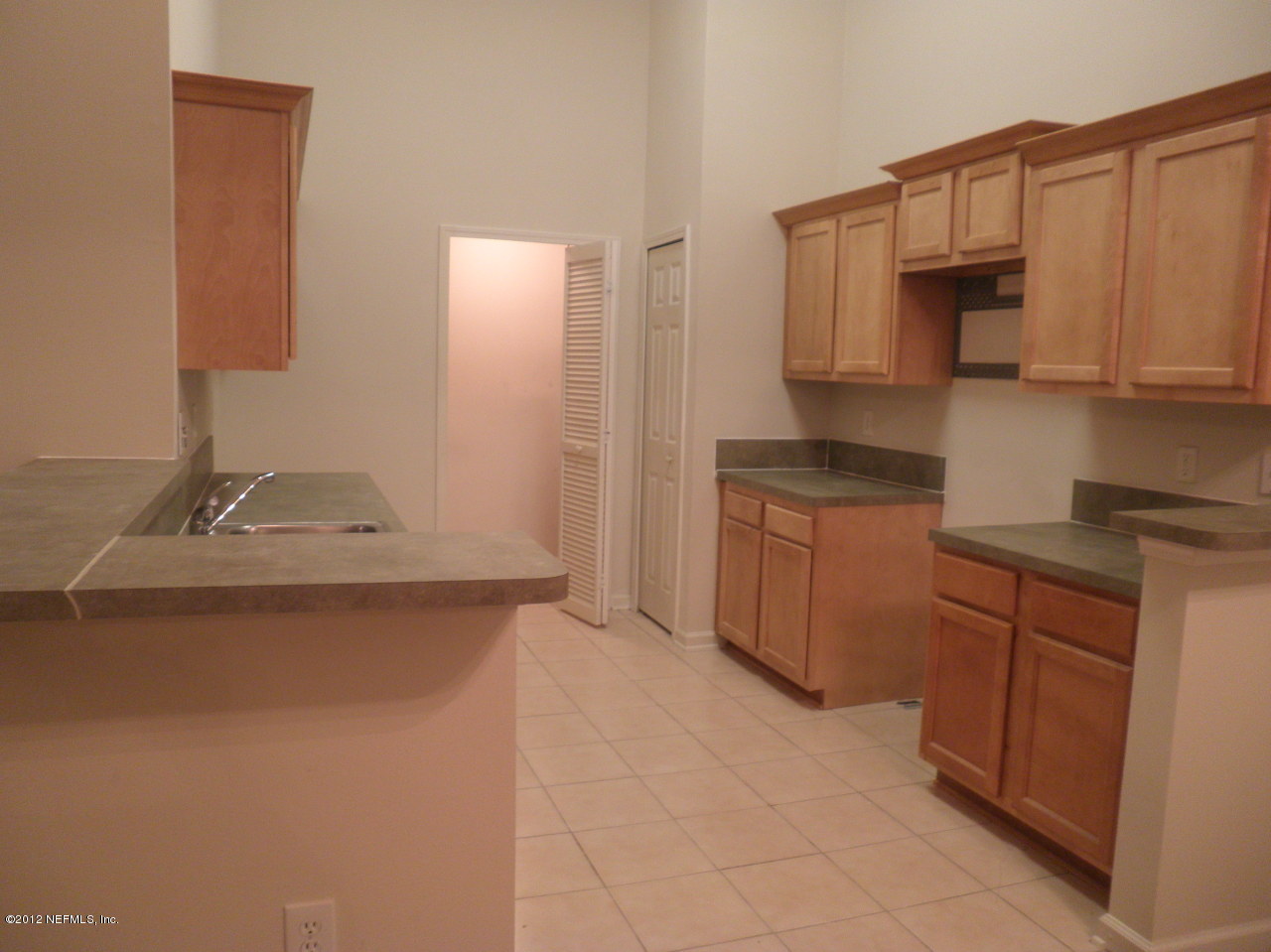 7920 Merrill Road, Unit 912 Jacksonville, FL 32277 - Photo 2 of 14 a kitchen with stainless steel appliances granite countertop a sink and cabinets