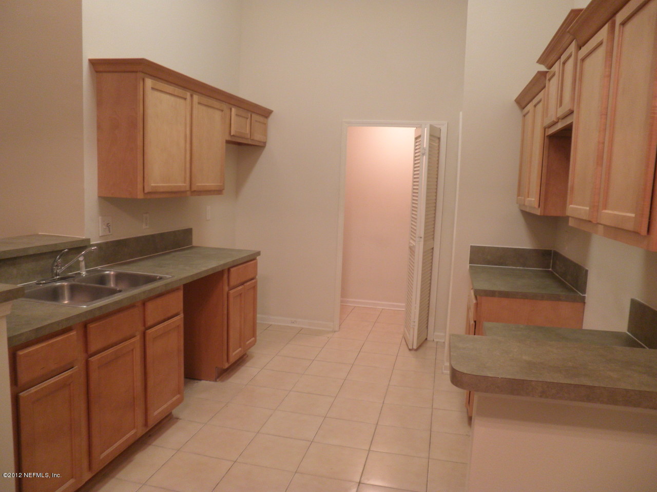 7920 Merrill Road, Unit 912 Jacksonville, FL 32277 - Photo 3 of 14 a kitchen with a sink and cabinets