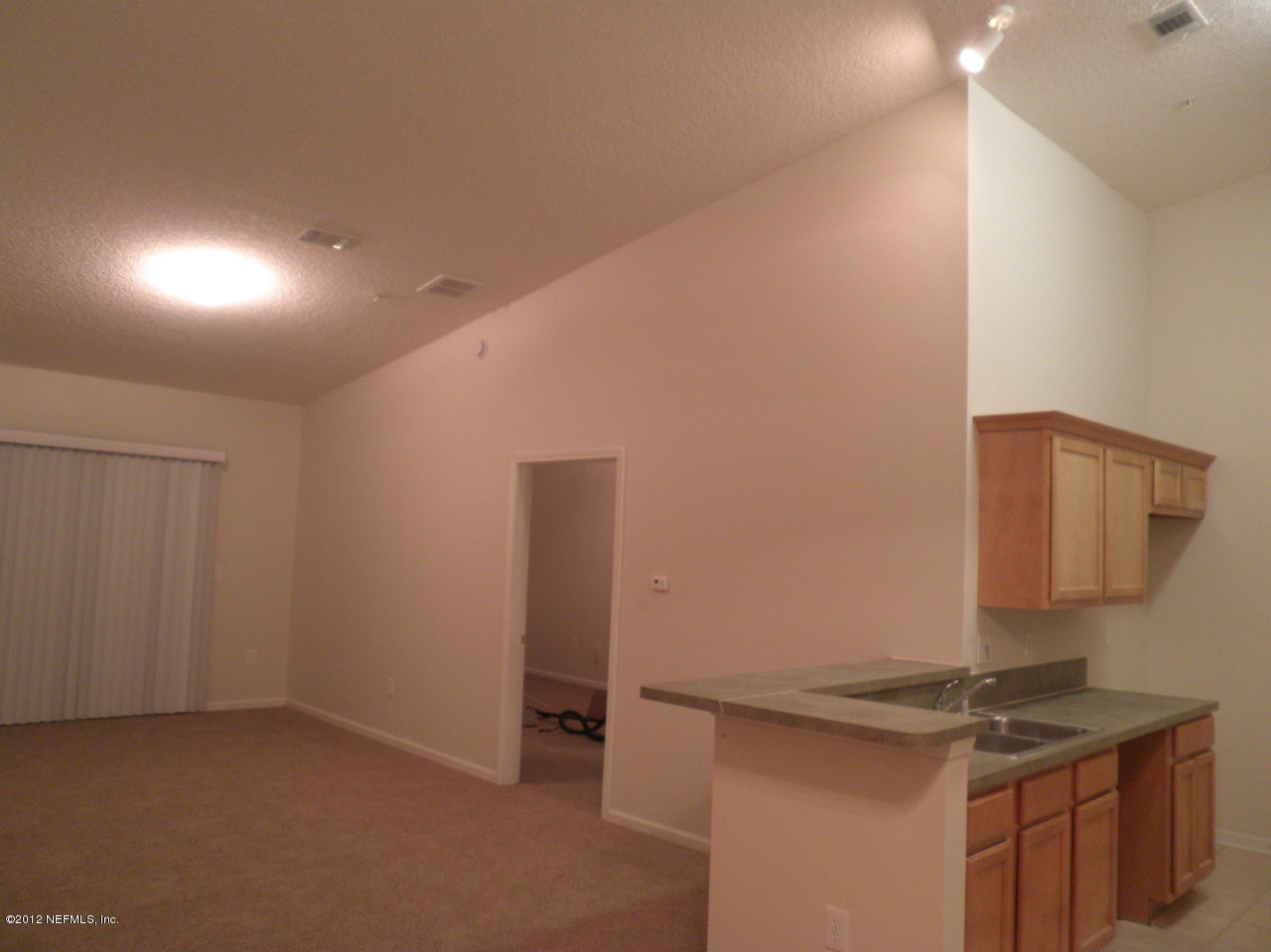 7920 Merrill Road, Unit 912 Jacksonville, FL 32277 - Photo 4 of 14 a kitchen that has a sink and a stove in it