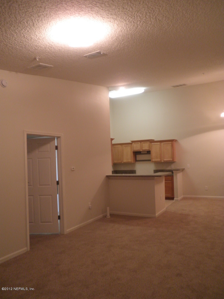 7920 Merrill Road, Unit 912 Jacksonville, FL 32277 - Photo 5 of 14 a kitchen that has a sink and a stove