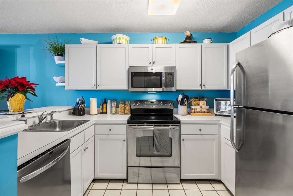 700 Shore Drive, Unit 810 Fall River, MA 02721 - Photo 11 of 22 a kitchen with a sink a stove and refrigerator