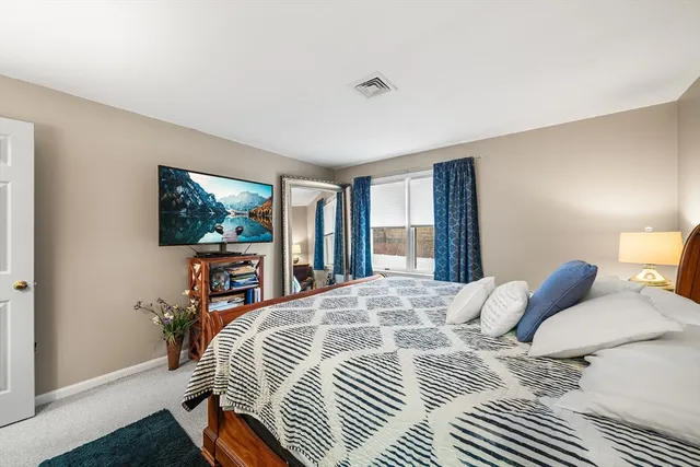 a bedroom with a bed and a dresser in it