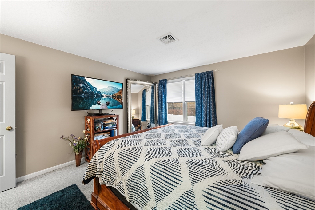 700 Shore Drive, Unit 810 Fall River, MA 02721 - Photo 13 of 22 a bedroom with a bed a large window and flat screen tv