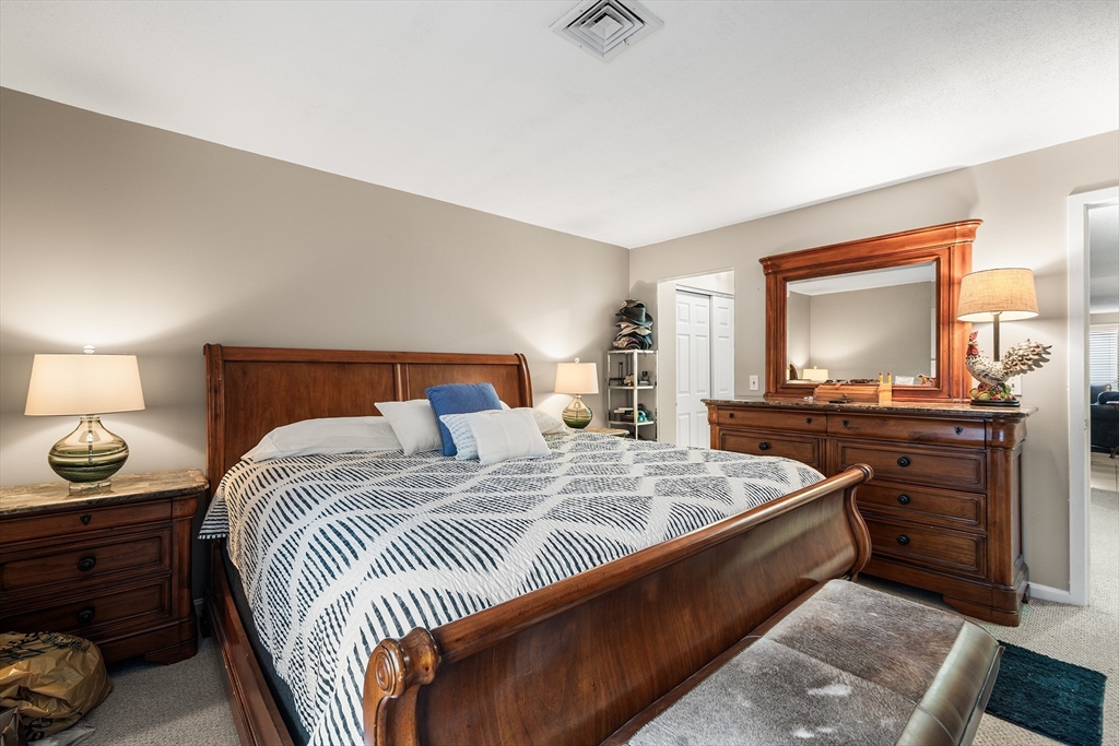 700 Shore Drive, Unit 810 Fall River, MA 02721 - Photo 14 of 22 a bedroom with a bed and a dresser in it