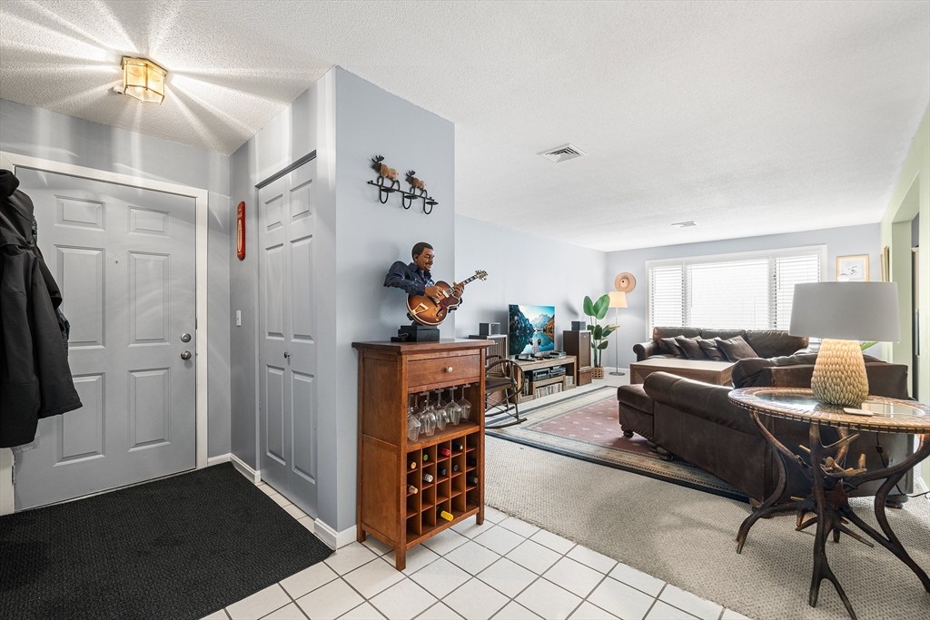 700 Shore Drive, Unit 810 Fall River, MA 02721 - Photo 2 of 22 a living room with furniture and a flat screen tv