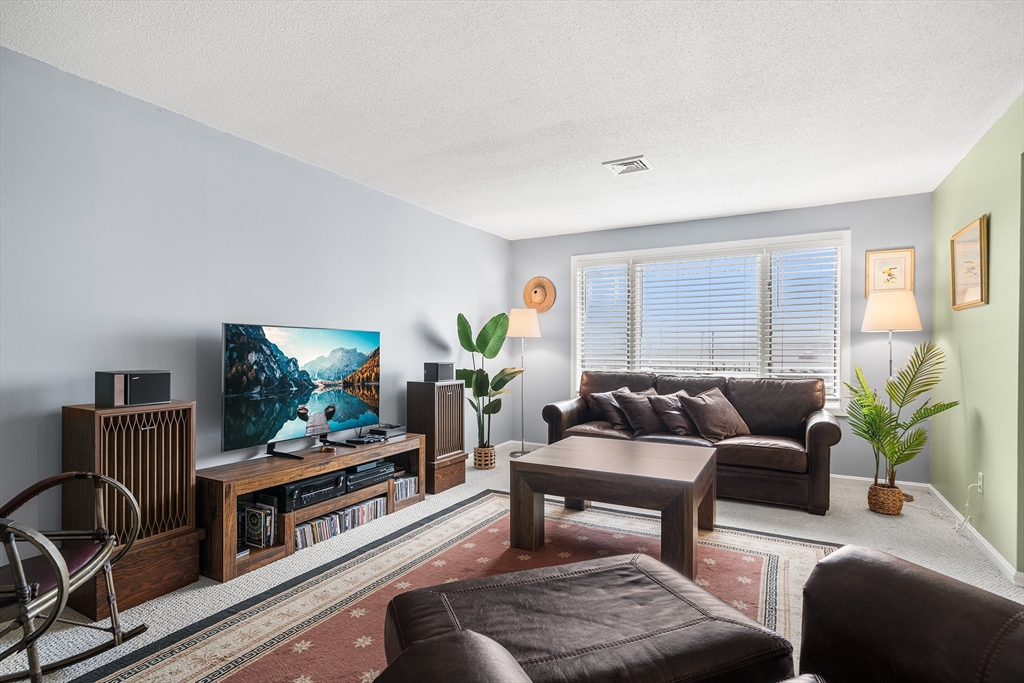 700 Shore Drive, Unit 810 Fall River, MA 02721 - Photo 3 of 22 a living room with furniture and a flat screen tv