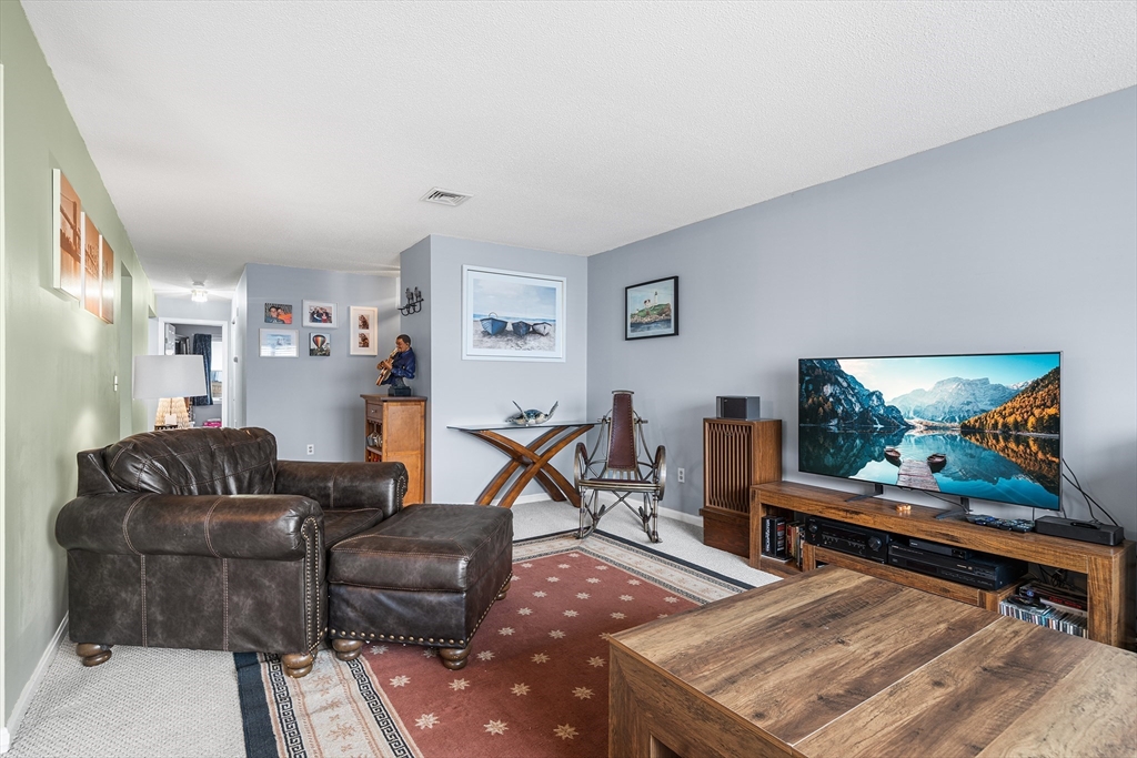 700 Shore Drive, Unit 810 Fall River, MA 02721 - Photo 4 of 22 a living room with furniture and a flat screen tv