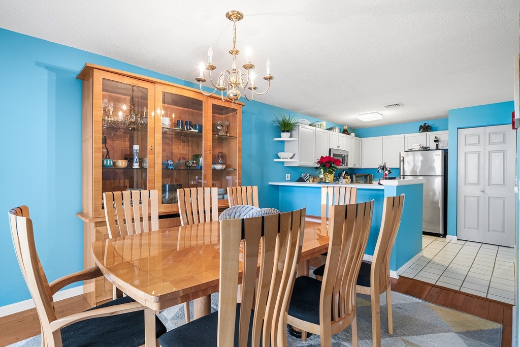 700 Shore Drive, Unit 810 Fall River, MA 02721 - Photo 9 of 22 a dining room with furniture a chandelier and wooden floor