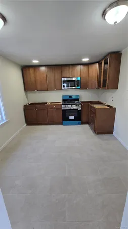 a large kitchen with stainless steel appliances a large counter top
