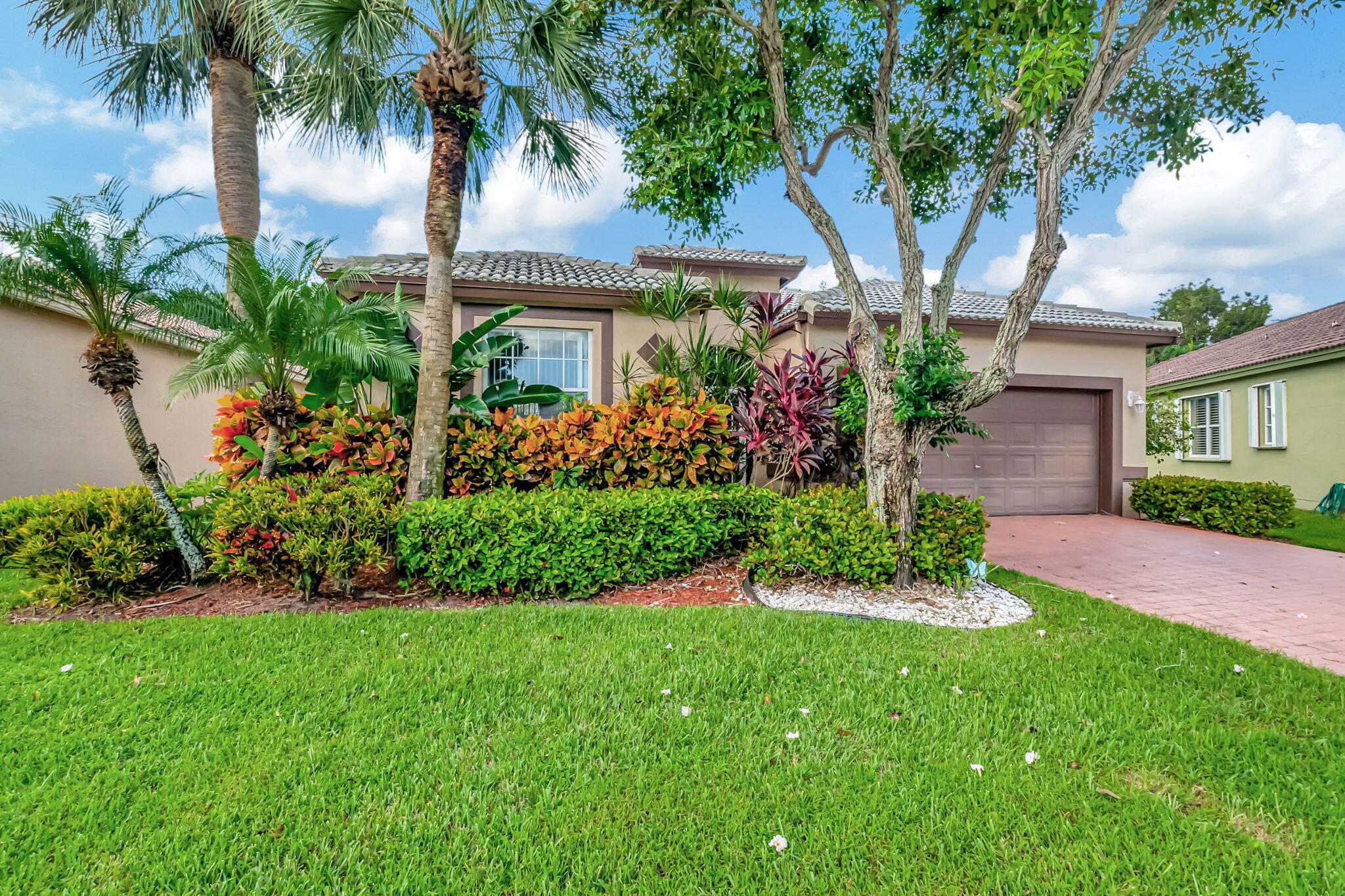 5916 Seashell Terrace Boynton Beach, FL 33437 - Photo 2 of 80 a front view of a house with a garden