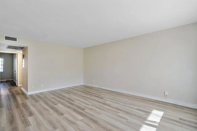 a view of a kitchen with wooden floor