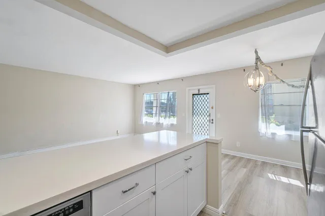 a kitchen with stainless steel appliances a refrigerator sink and microwave