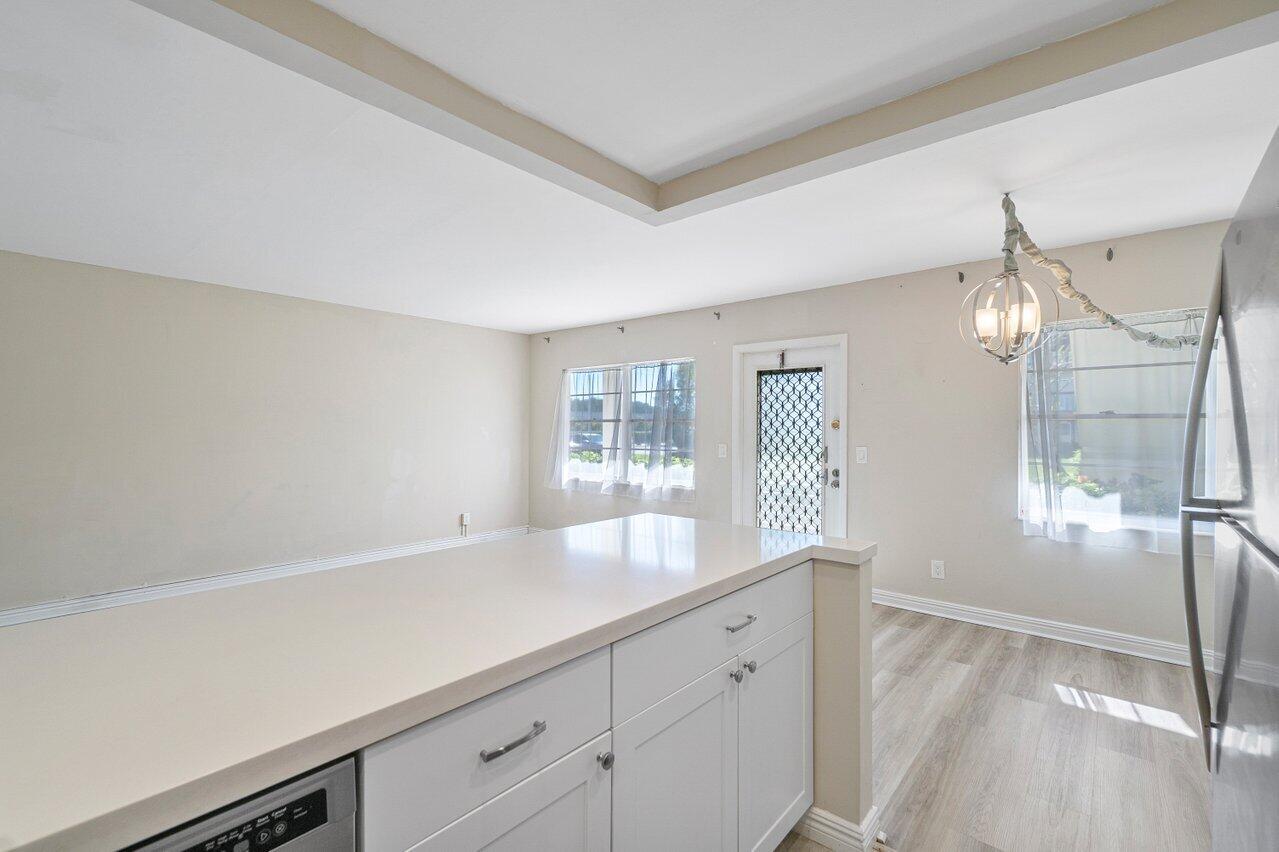517 Fanshaw M Boca Raton, FL 33434 - Photo 15 of 28 a view of a kitchen and wooden floor