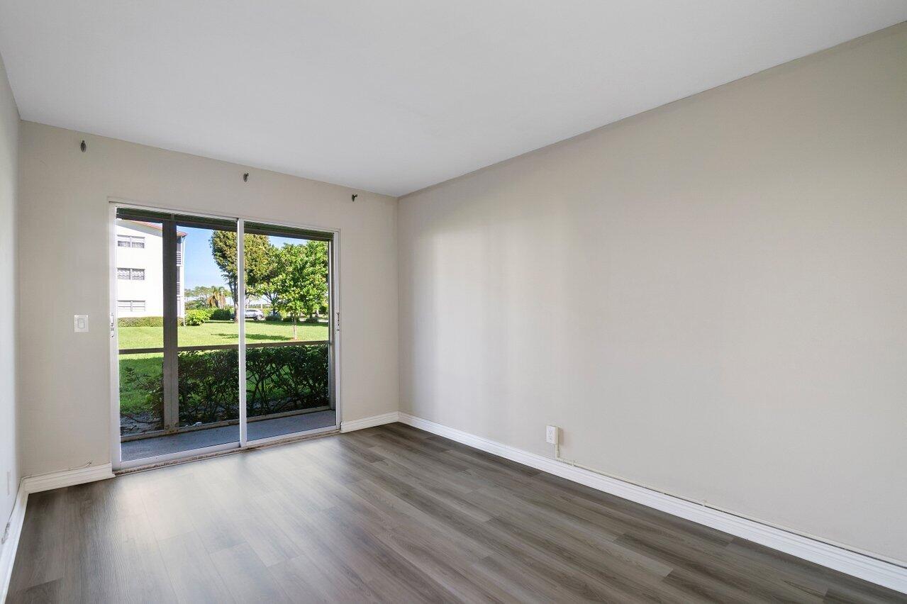 517 Fanshaw M Boca Raton, FL 33434 - Photo 18 of 28 a view of a room that has wooden floor and a window