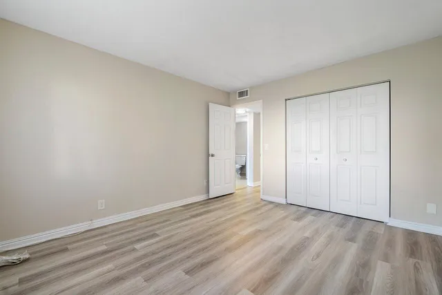 a bathroom with a sink a toilet a mirror and shower