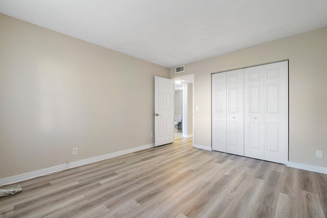 517 Fanshaw M Boca Raton, FL 33434 - Photo 22 of 28 a view of an empty room and wooden floor