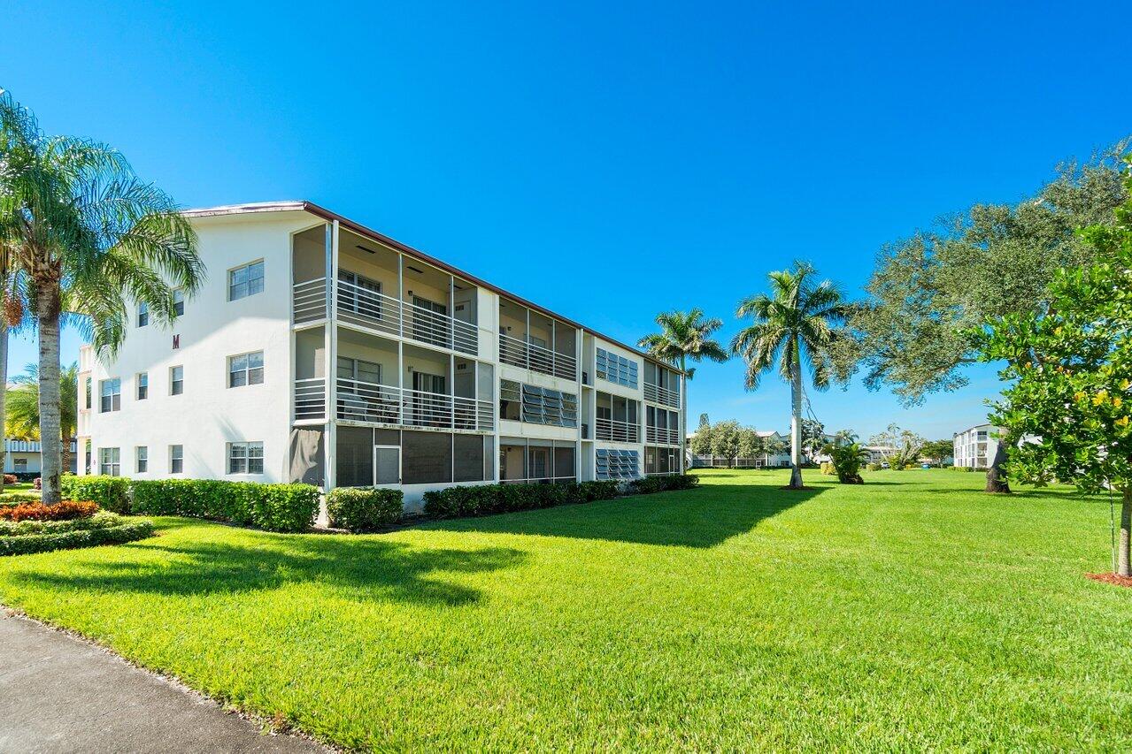 517 Fanshaw M Boca Raton, FL 33434 - Photo 26 of 28 a view of a house with a yard