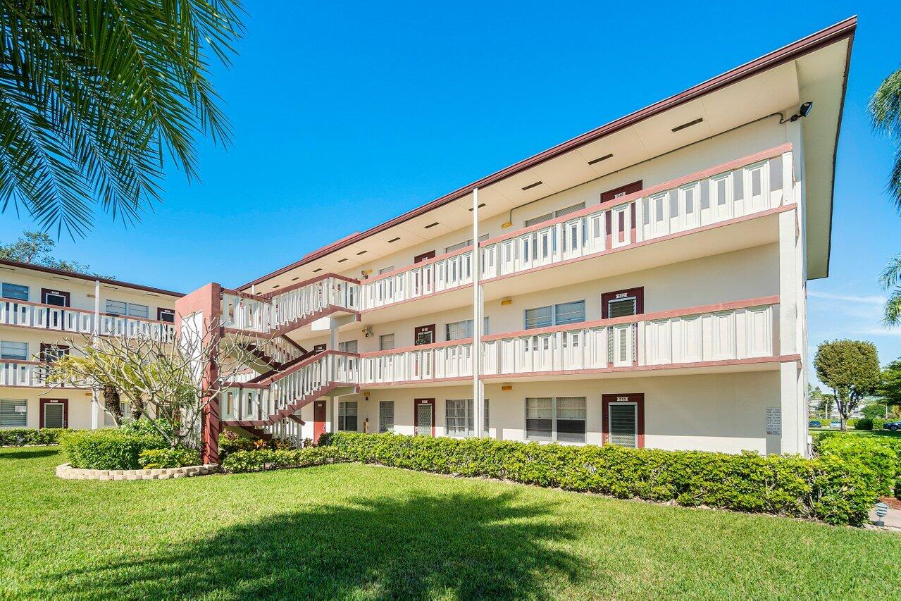 517 Fanshaw M Boca Raton, FL 33434 - Photo 3 of 28 a front view of a house with a yard