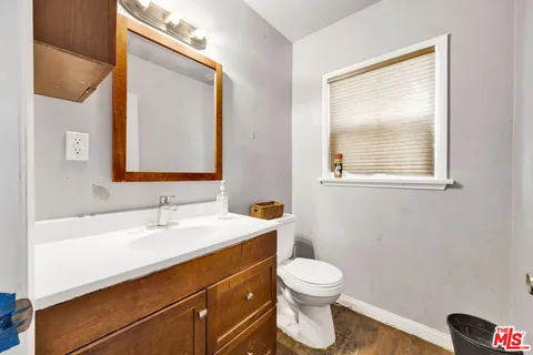 a bathroom with a toilet sink and mirror