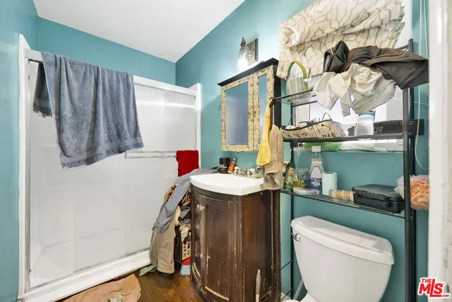 a bathroom with a sink a toilet and a mirror