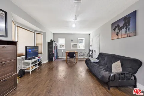 a living room with furniture and wooden floor