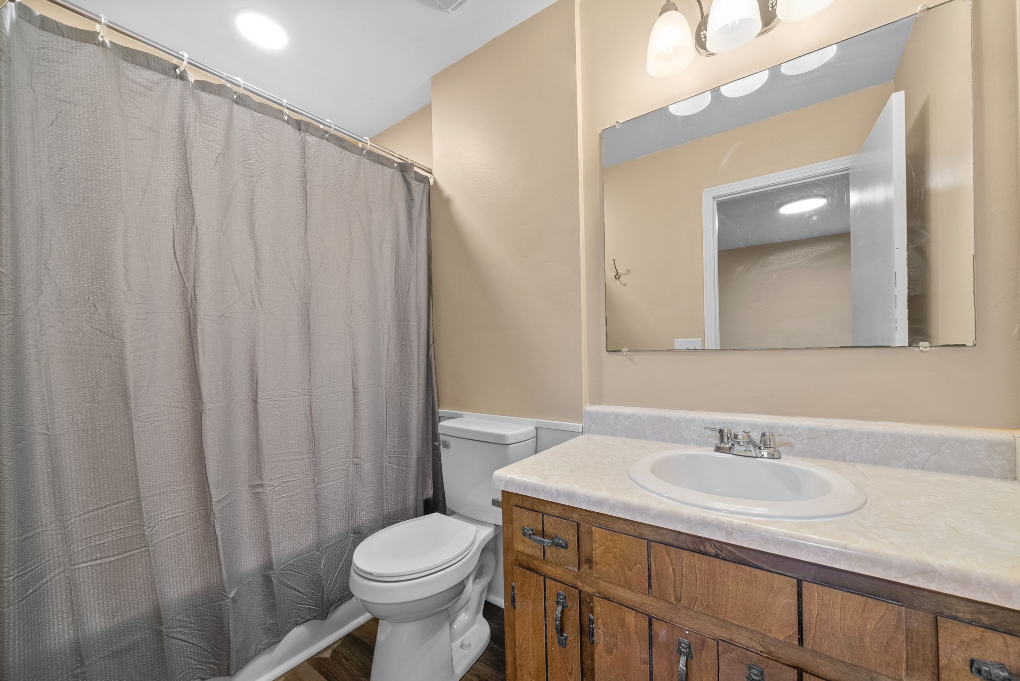 619 Ranch Hill Drive Clarksville, TN 37042 - Photo 23 of 32 a bathroom with a sink a toilet a mirror and shower curtain