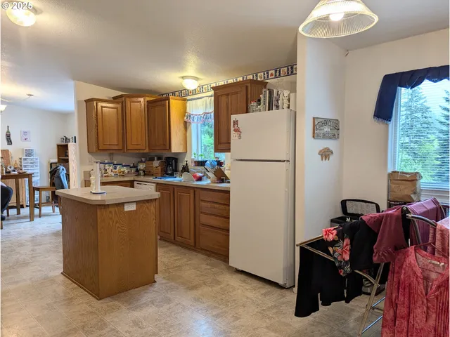 a kitchen with refrigerator and cabinets