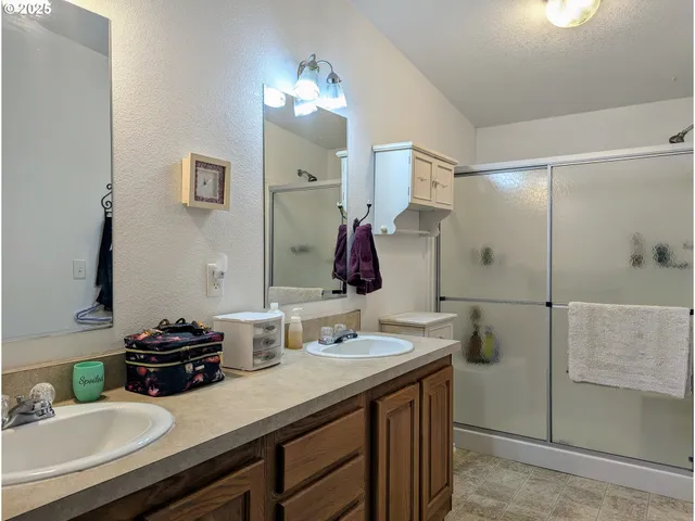 a bathroom with a sink double vanity and a mirror