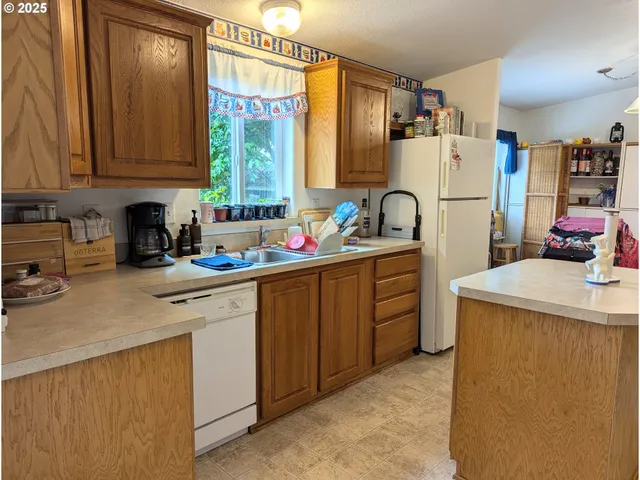 a kitchen with sink cabinets and window