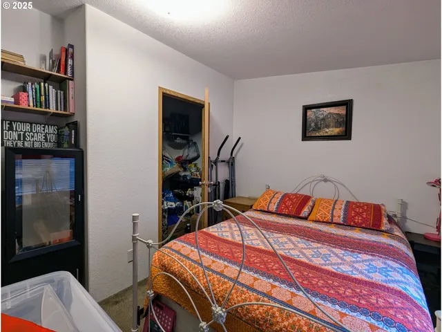 a bedroom with a bed and a book shelf