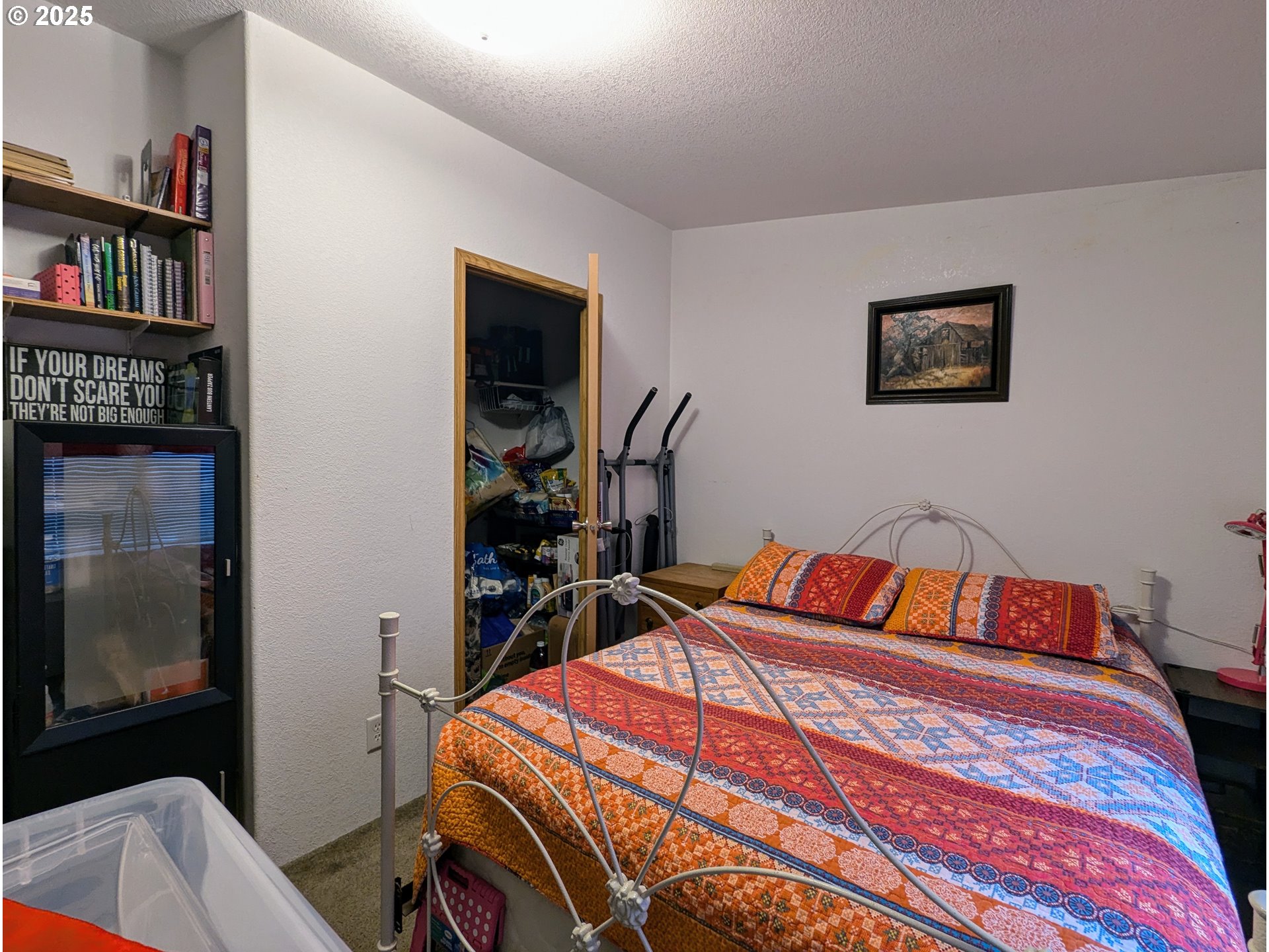 49244 Mountain View Road Oakridge, OR 97463 - Photo 6 of 30 a bedroom with a bed and a book shelf