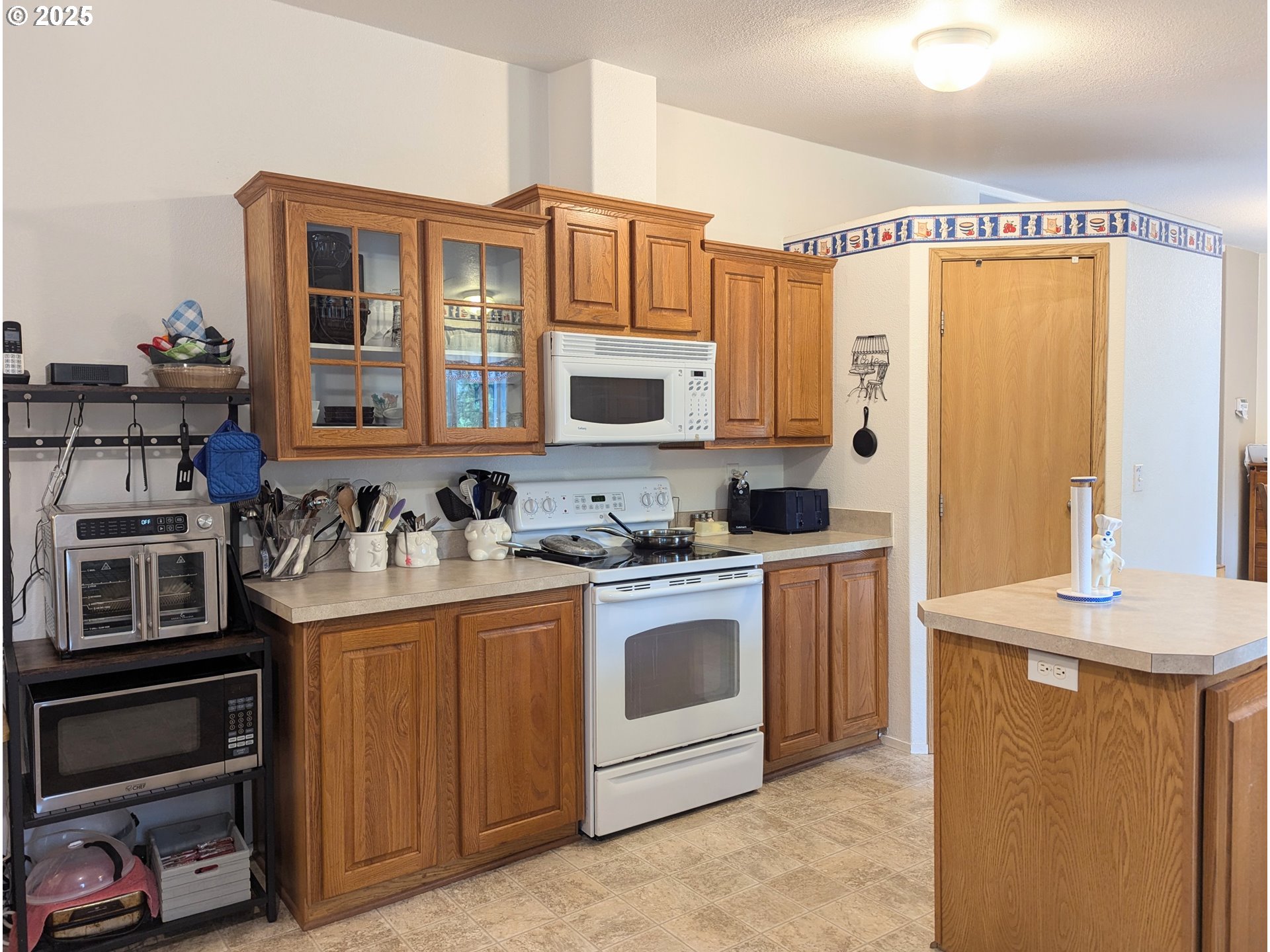 49244 Mountain View Road Oakridge, OR 97463 - Photo 10 of 30 a kitchen with stainless steel appliances granite countertop a stove and cabinets