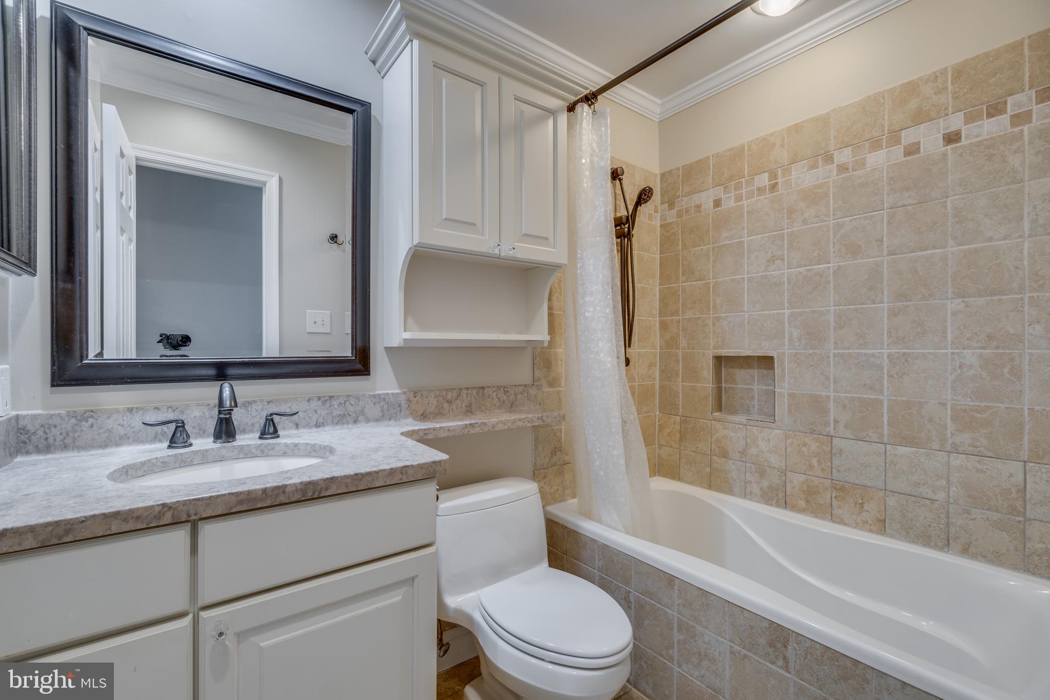 2069 Cobblestone Lane Reston, VA 20191 - Photo 13 of 35 a bathroom with a sink a toilet and shower