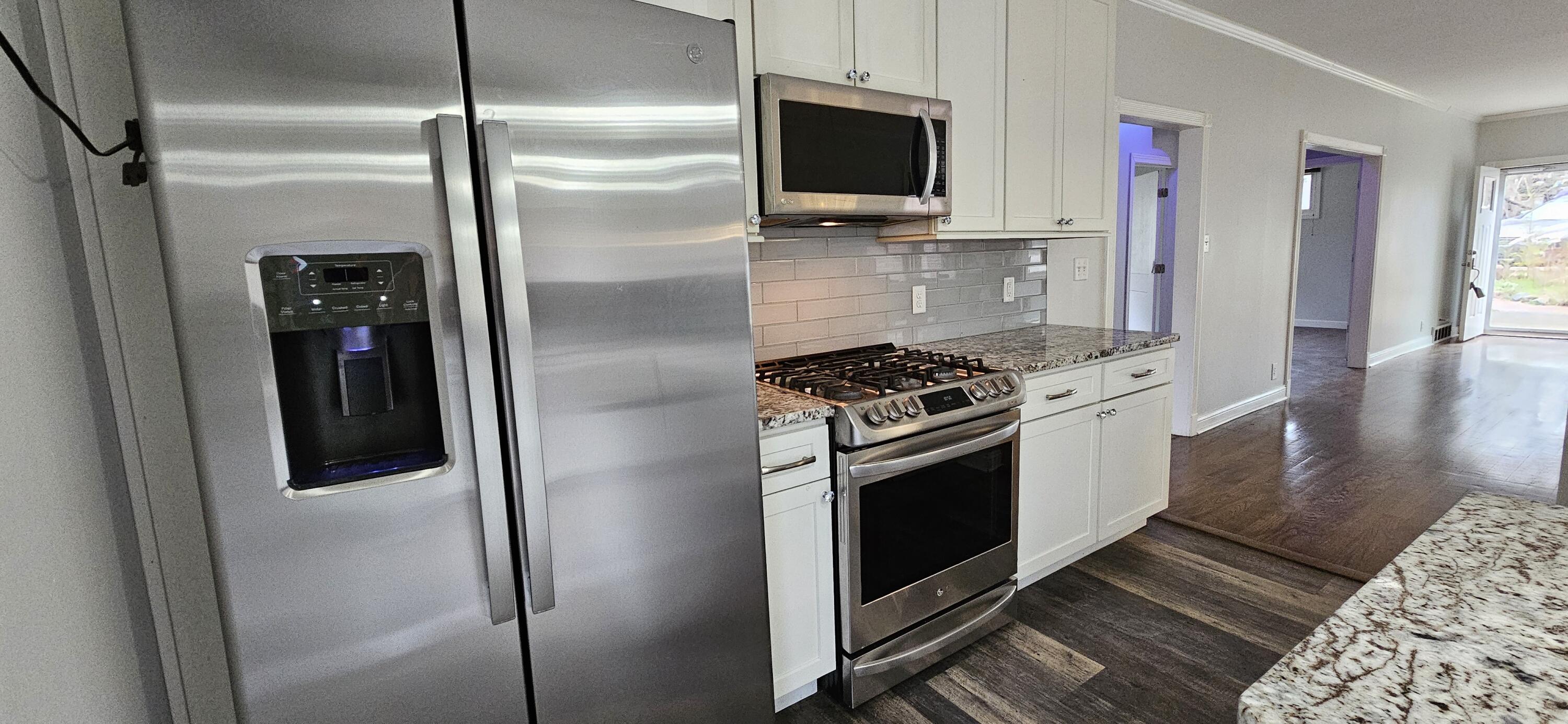 7419 Maple Avenue Gary, IN 46403 - Photo 23 of 93 a kitchen with stainless steel appliances kitchen island granite countertop a refrigerator stove and microwave