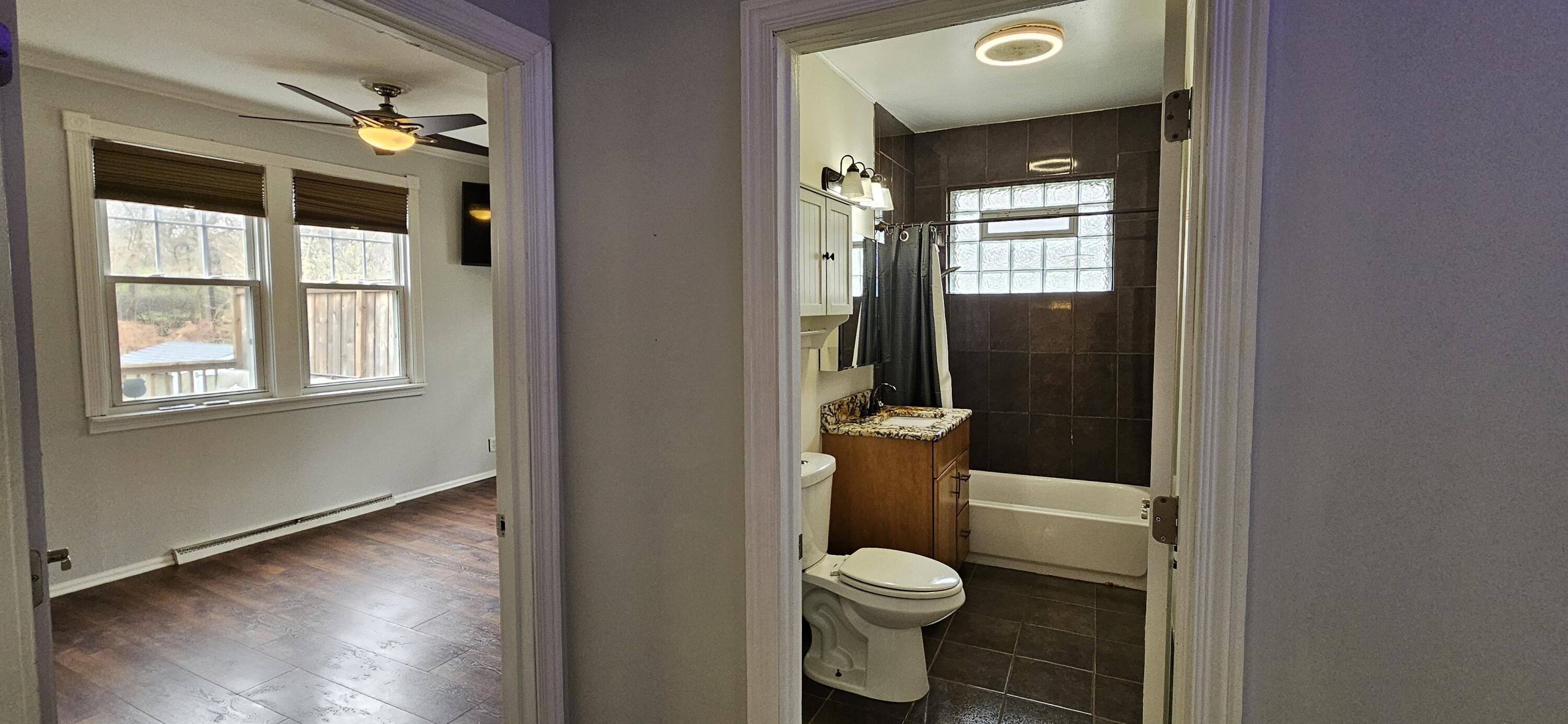 7419 Maple Avenue Gary, IN 46403 - Photo 26 of 93 a bathroom with a toilet a window and shower