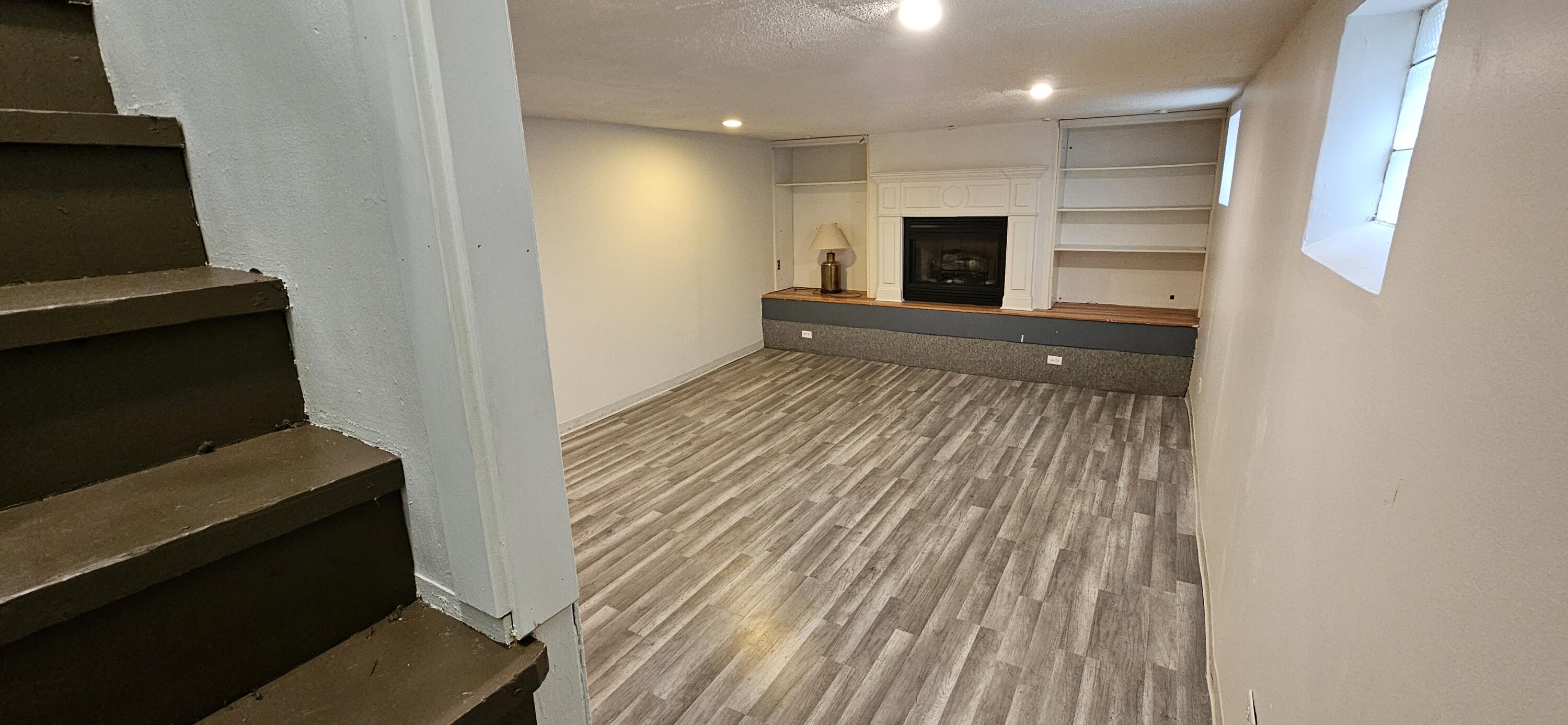 7419 Maple Avenue Gary, IN 46403 - Photo 58 of 93 a view of a hallway with wooden floor and a fireplace