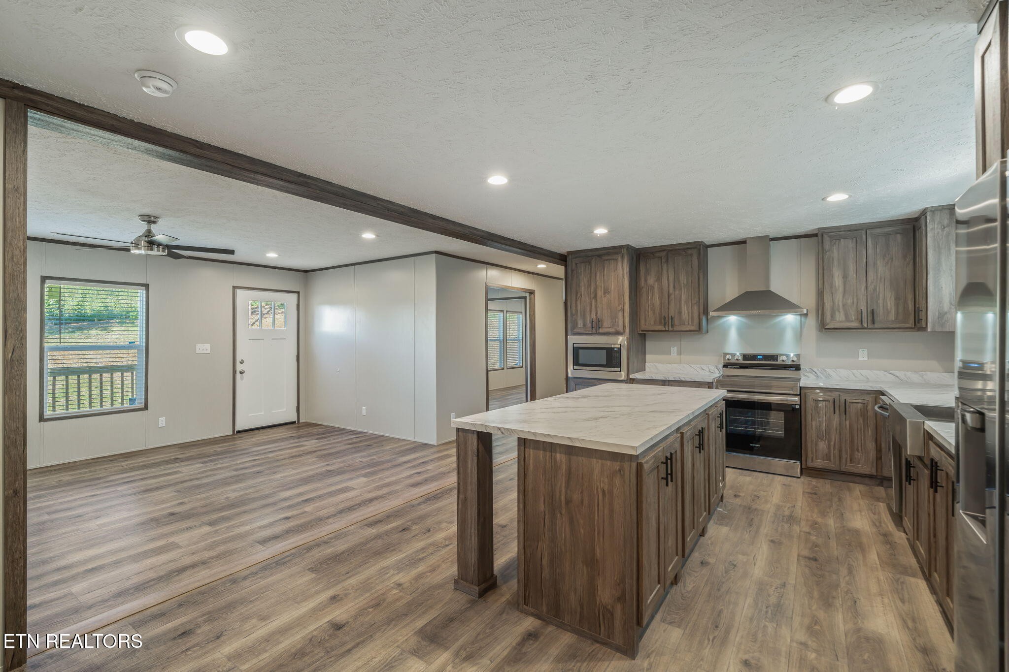 400 Matlock Trail Loudon, TN 37774 - Photo 14 of 50 a kitchen with kitchen island granite countertop a stove oven a sink dishwasher and a refrigerator with wooden floor