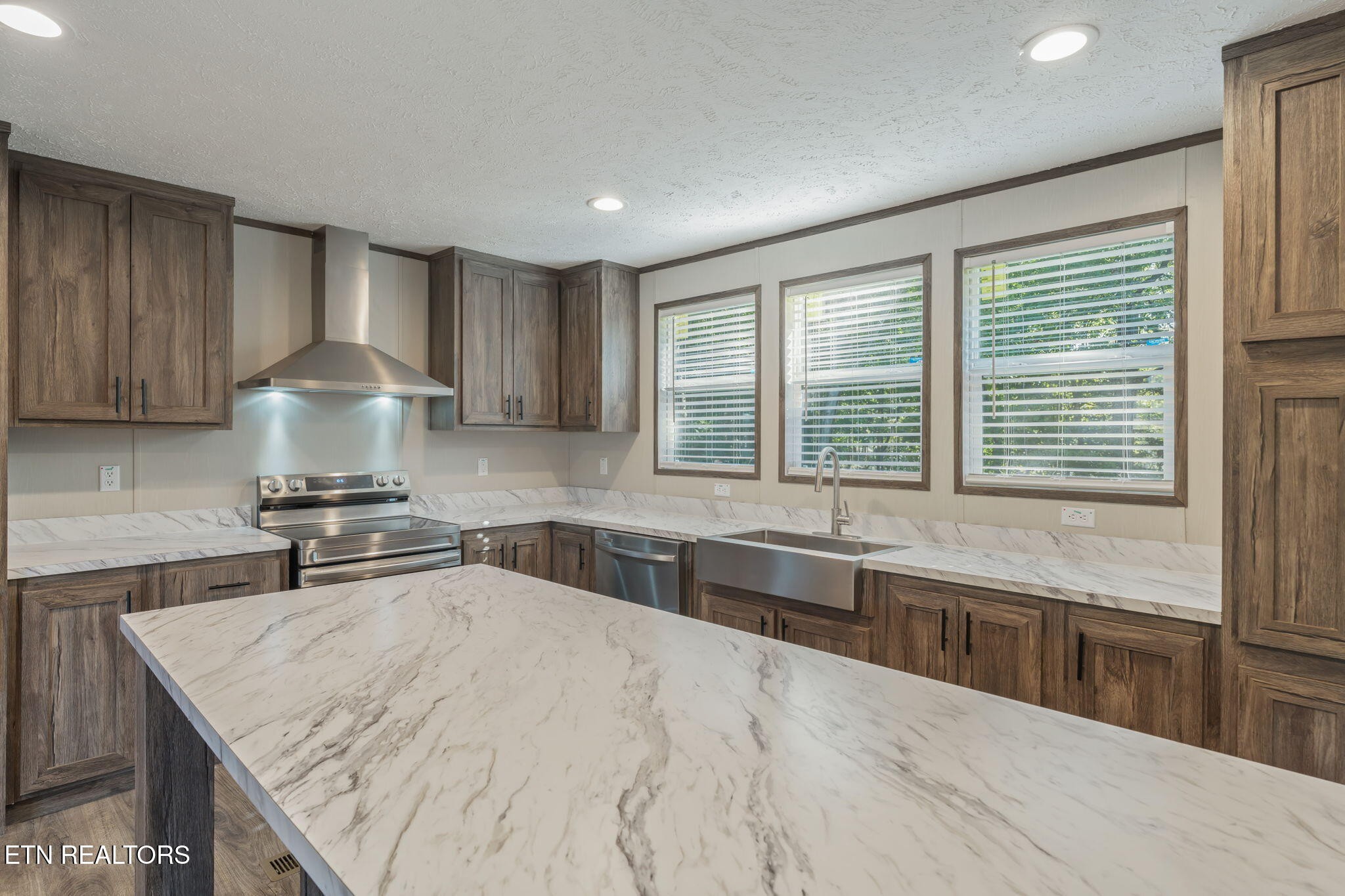 400 Matlock Trail Loudon, TN 37774 - Photo 18 of 50 a kitchen with stainless steel appliances granite countertop a sink stove and cabinets