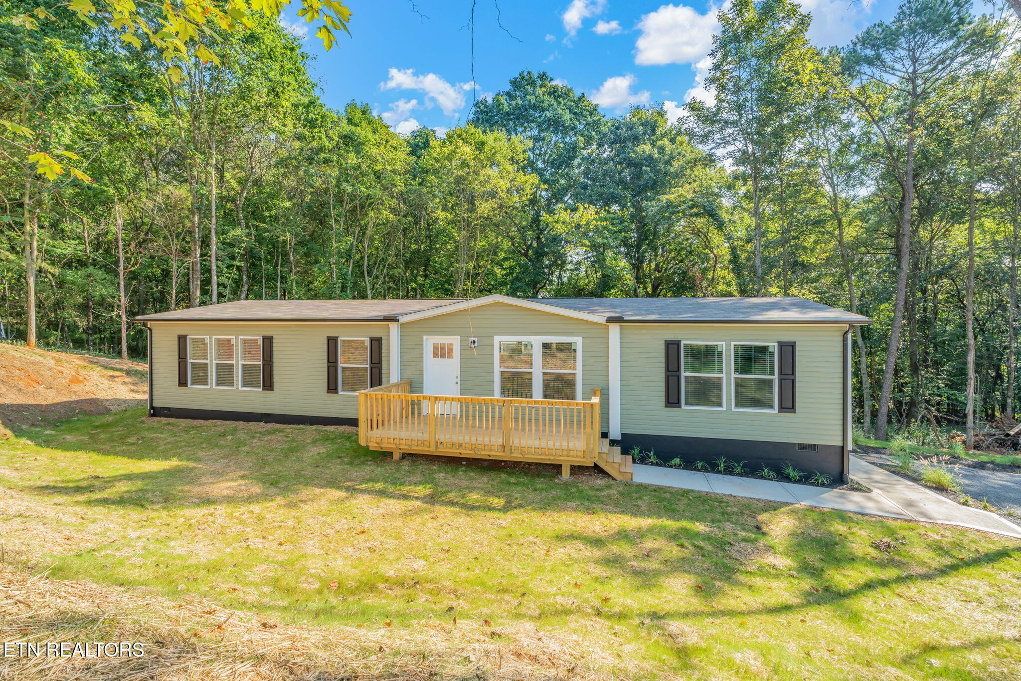 400 Matlock Trail Loudon, TN 37774 - Photo 2 of 50 a front view of a house with a yard table and chairs