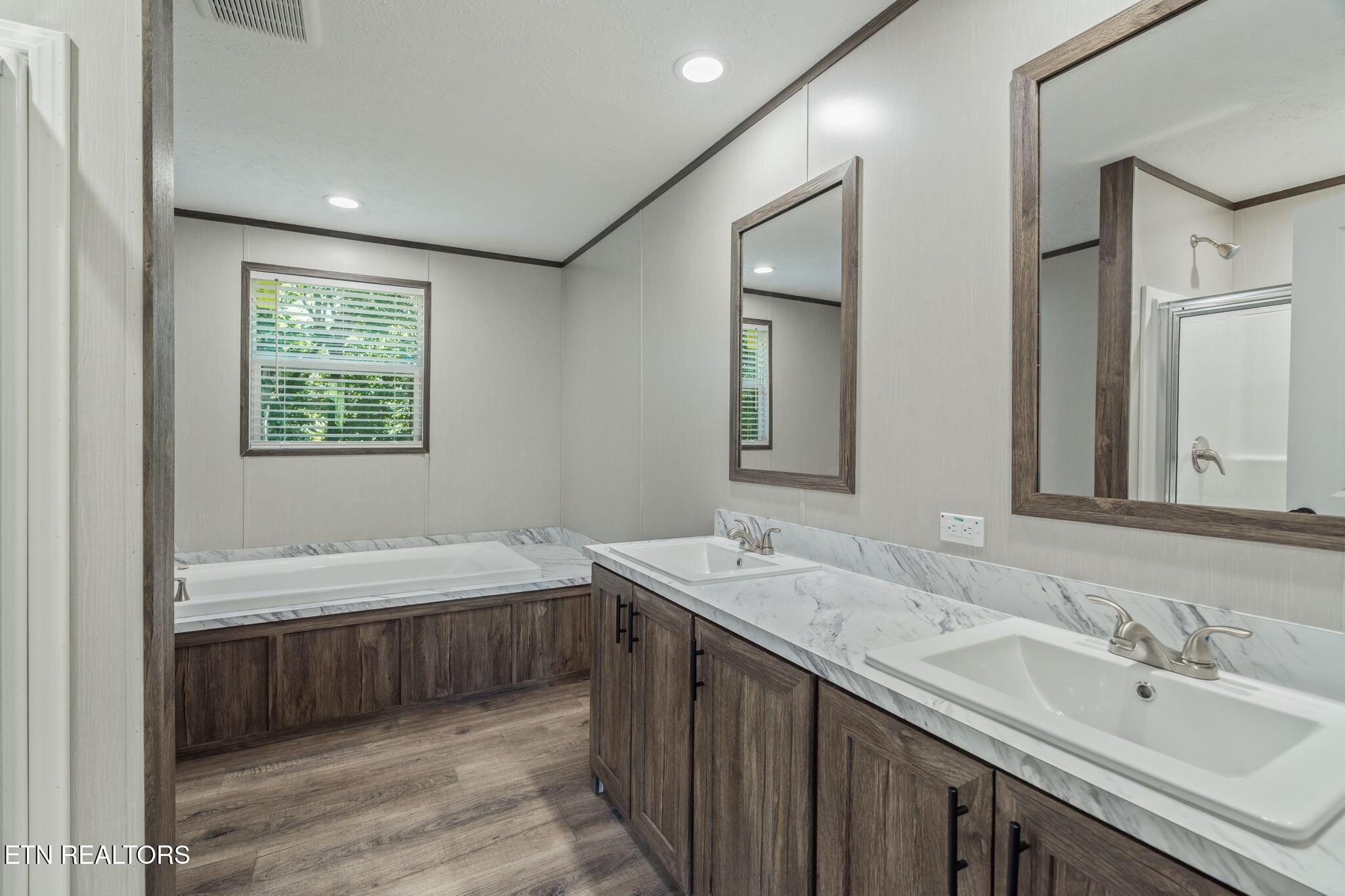 400 Matlock Trail Loudon, TN 37774 - Photo 23 of 50 a spacious bathroom with a double vanity sink large mirror and a bathtub